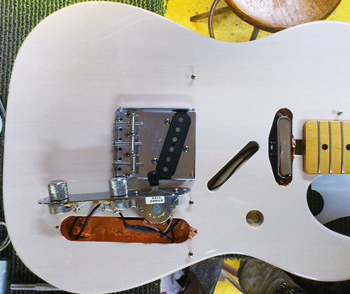 electronics and hardware are placed back in the telecaster body