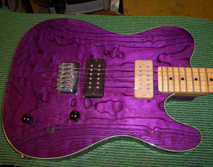 purple telecaster with wooden pickup covers